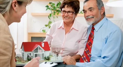 Senior couple discussing with consultant