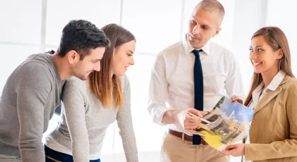 Young couple consult with two real estate agent