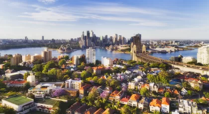 an aerial view of Sydney with the Sydney Opera House in the background