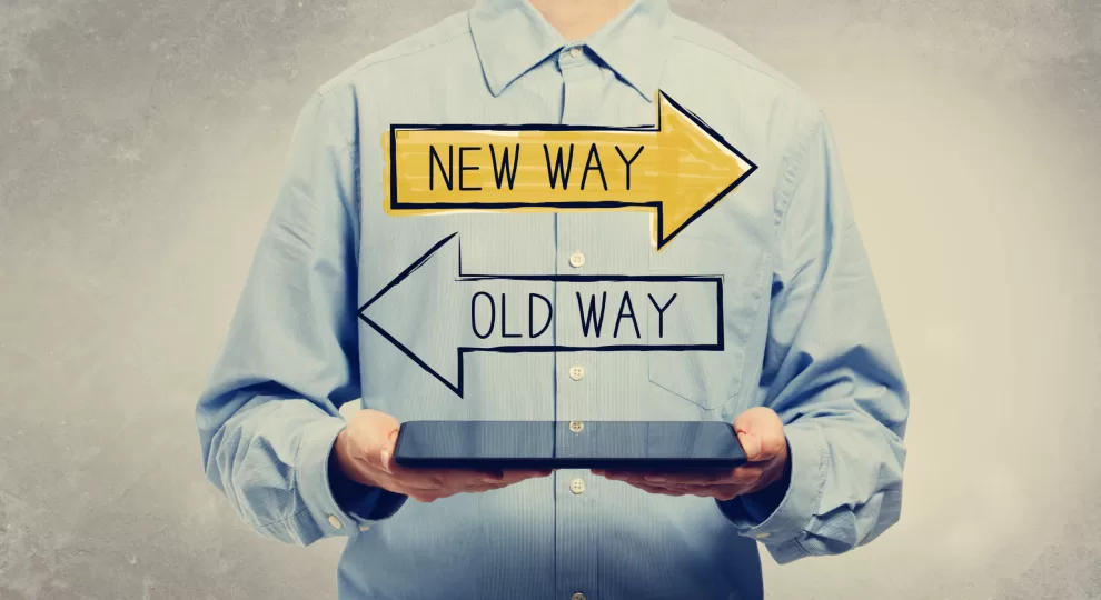 a man wearing a light blue shirt with two arrows with the words New Way and Old Way on them