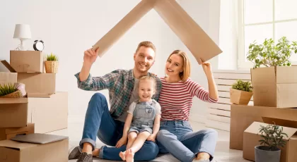 a man, a woman, and a little girl under a makeshift roof