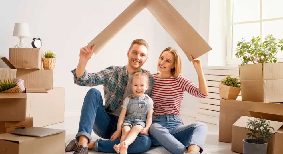 a man, a woman, and a little girl under a makeshift roof