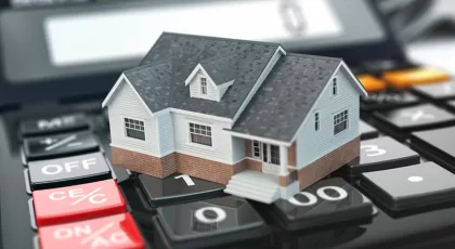 tiny model house on a mortgage calculator