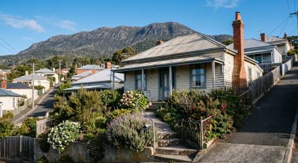 Weatherboard cottage on a Hobart hillside street