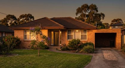 Modest Australian brick home photographed at golden hour