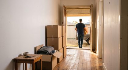 Tenant moving boxes out of a rental home on the day they break the lease early