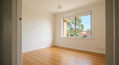 Clean, empty bedroom in an Australian rental at the end of a tenancy, after the bond claim inspection
